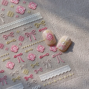 Stereo bow and lace embossed nail art stickers with pearl accents on pink nails
