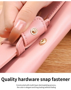 Detailed macro view of a durable golden metal snap fastener on a pink leather wallet
