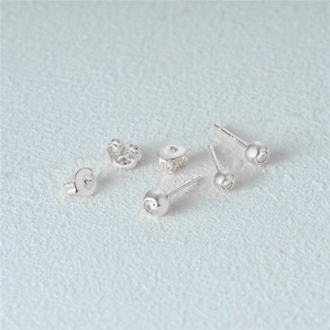Detailed view of s925 silver stud earrings with sparkling cubic zirconia and backings