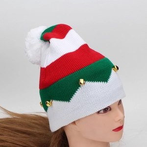 Detail of red and green striped knit Christmas hat with white pompom and gold bells