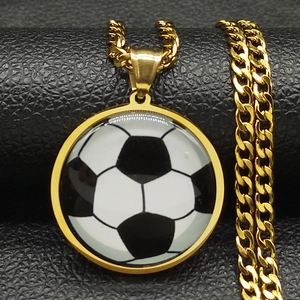 Macro shot of a golden soccer pendant necklace with a detailed black and white ball design