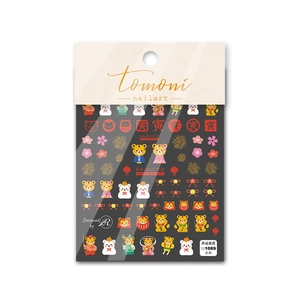 Detail of 5D embossed Japanese nail stickers with red and gold cartoon tiger motifs