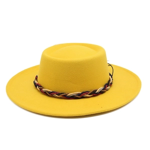 Detail of bright yellow wool fedora with a colorful woven band and wide brim flat top