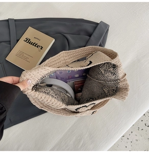 Vue de dessus montrant l'intérieur spacieux du sac cabas en tricot beige à motifs noirs