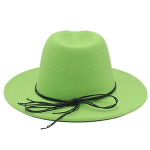 Detail of emerald green felt cowboy hat with a black string bow and wide brim