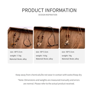 Detailed view of resin flower and heart pendants on brown cord with size and weight specs