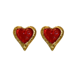 Vintage gold hammered heart earrings with red translucent resin centers in a retro style