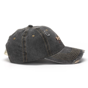 Detail view of vintage washed baseball cap featuring side embroidery and distressed edges