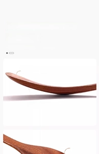 Detailed view of ebony wood spatula showing tapered edge and thick handle design