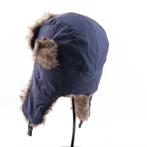 Close-up of blue waterproof trapper hat with brown faux fur lining and adjustable buckle strap