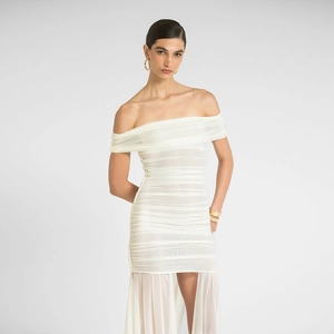 Detail of white strapless dress featuring ruched fabric and asymmetric draped hemline