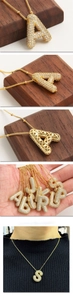 Detail showing gold plated balloon letter pendant with zircon micro-pave setting