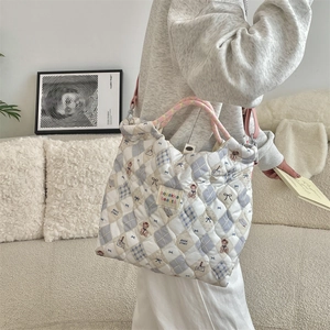 Quilted cartoon bear handbag shown styled in a cozy lifestyle setting for daily use