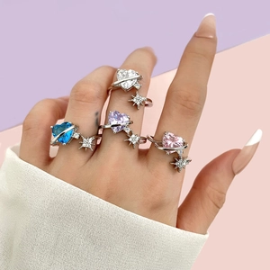 Detailed shot of multi-color heart zircon rings with Saturn star pendants in 18k gold