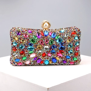 Macro shot of colorful faceted gemstones and rhinestones on luxury evening clutch bag