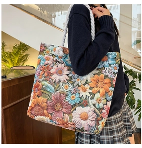 Close-up of floral embroidery texture and woven rope handle on women shoulder bag