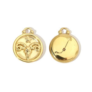 Macro detail of Aries zodiac 14K gold-plated stainless steel charms with crystal inlay