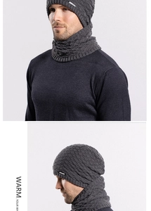 Detail view of dark grey knitted beanie and neck warmer set with thick ribbed texture