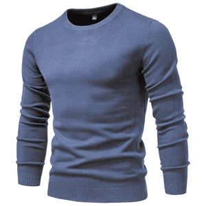 Detailed view of grey blue knit sweater showing fine texture and crew neck collar ribbing