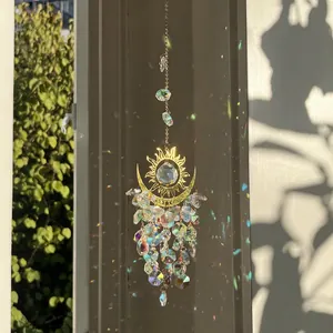 Bohemian crystal suncatcher with celestial gold motifs and rainbow light reflections