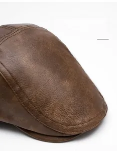 Macro shot of dark brown leather beret detailing curved brim and reinforced stitching