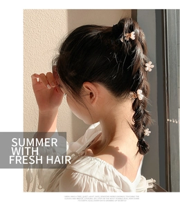 Close-up of mini pearl flower hair clips styled in a half-up hairstyle for women