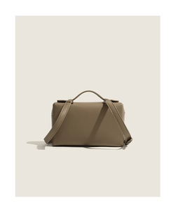 Detailed view of the textured taupe leather surface and stitching on the handle bag