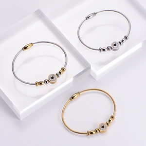 Set of three stainless steel cable bracelets with diamond-encrusted heart charms