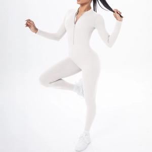 Close-up of beige athletic jumpsuit with half-zipper collar and long sleeves for yoga