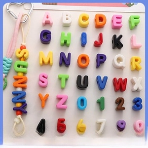 DIY craft kit with colorful square alphabet and number beads on a heart metal hook