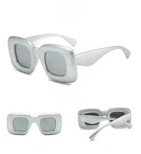 Three-angle view of silver Y2K wrap sunglasses with bold square frames and grey lenses