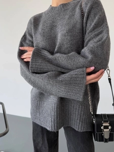 Detailed knit texture of a dark grey oversized loose-fit sweater with dropped shoulders