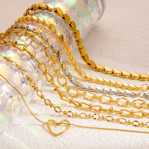 Handmade woven titanium steel leaf bracelet in gold and silver finish with heart pendant