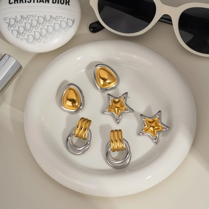 Minimalist geometric earring set in gold and silver finish with triangle and star studs