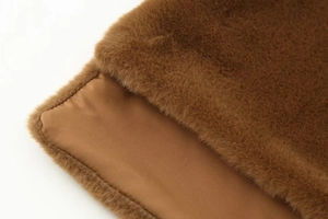 Detailed close-up of brown faux fur texture and smooth inner lining of the warm shawl