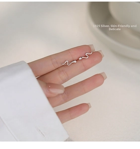 Close-up of S925 sterling silver snake earrings with sparkling crystal accents