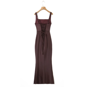 Detail of elegant backless satin evening dress with cross-straps and floor-length hem