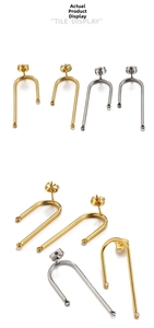 Detailed view of U-shaped gold and silver stainless steel earring hooks with ear plugs