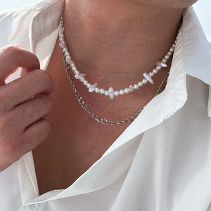 Hip hop layered necklace with baroque pearls and silver Cuban chain on male model