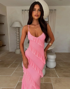 Detail of pink ruffled layers on a backless slim fit dress with a side slit design