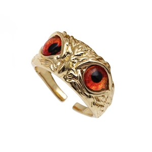 Golden owl open ring with red eyes and detailed relief texture on a clean white background