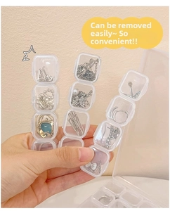 Close-up of detachable 4-slot clear acrylic jewelry storage box held in hand