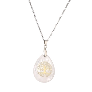Macro shot of silver tree of life pendant featuring translucent crystal waterdrop detail
