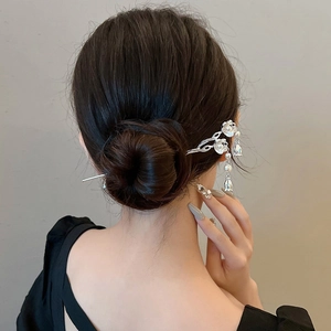 Detail showing silver lily of the valley hair stick with pearl tassels on hairstyle