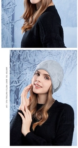 Detail of grey knitted beanie featuring diamond textures and small pearl embellishments
