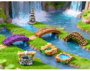 Detail of miniature resin bridges and stone well for fairy garden landscaping