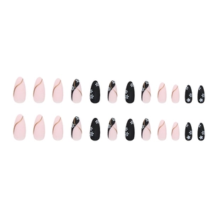 Matte almond press-on nails with pink and black floral designs and gold accents