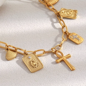18K gold plated stainless steel bracelet with cross, shell and evil eye charms
