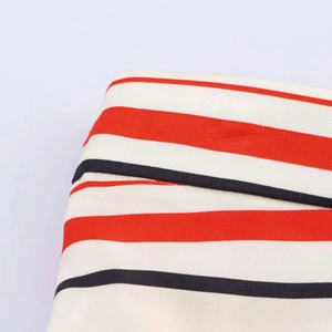 Detailed close-up of red and black striped fabric with professional stitching and texture