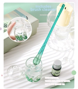 Detail of green glass dip pen and matching pen wash jar with delicate lily pattern